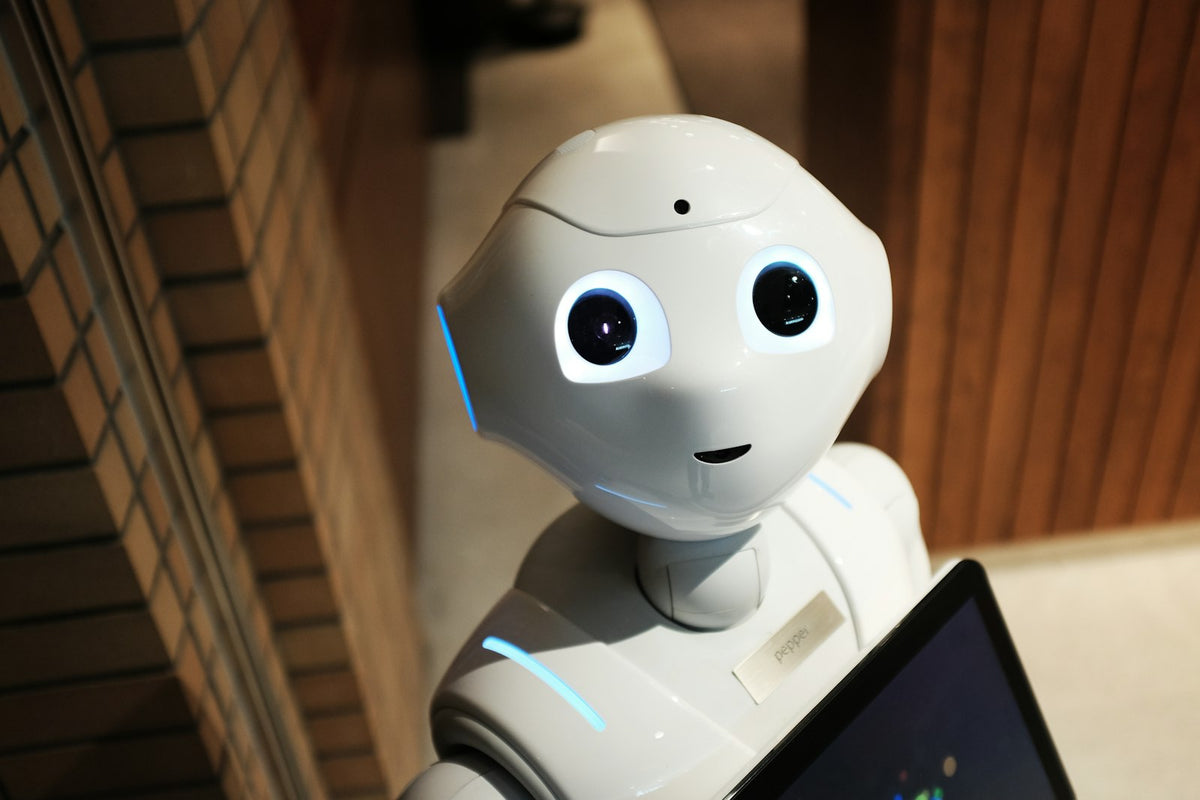 A small white robot figure against a plain background