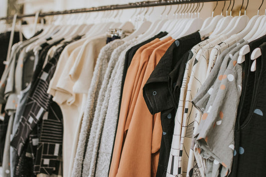 A person holding up a phone to photograph a product in a shop