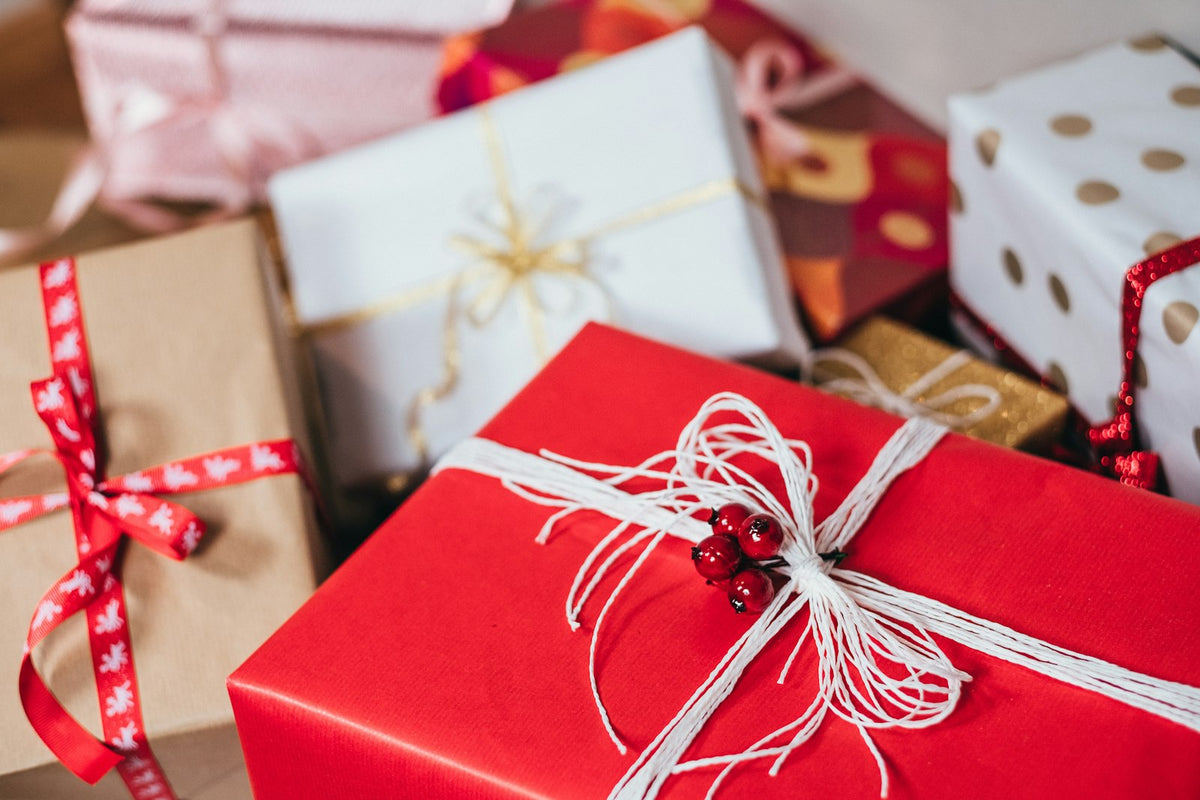 A wrapped gift box with a ribbon on a table