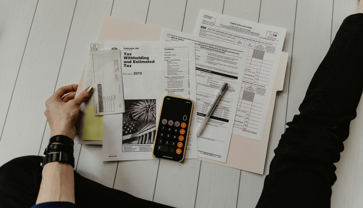 A calculator and printed receipts on a desk